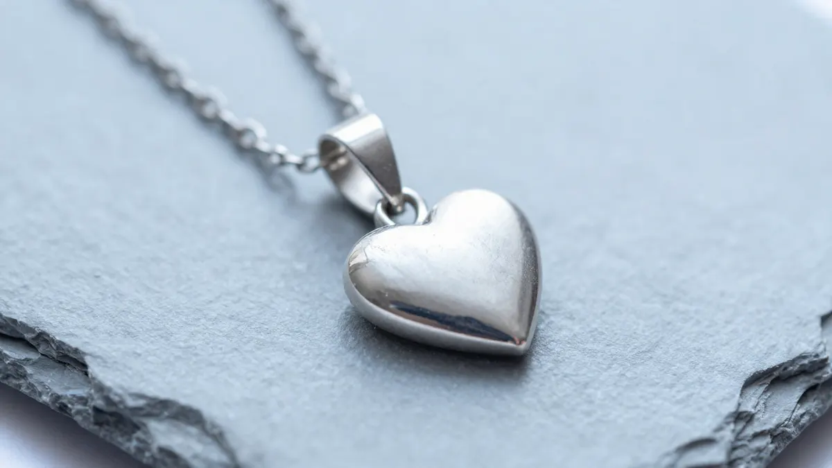 Sterling silver heart melting pendant necklace with a softly curved heart shape on a fine chain