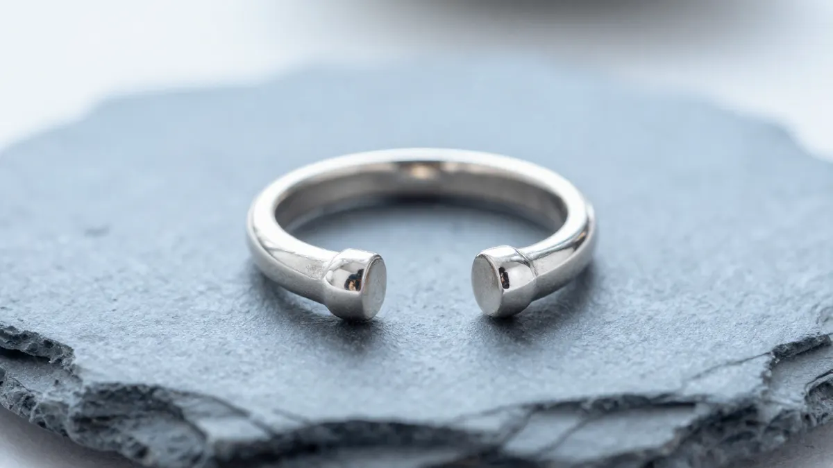 925 silver ball toe ring with a smooth round bead resting on a grey stone background in soft light