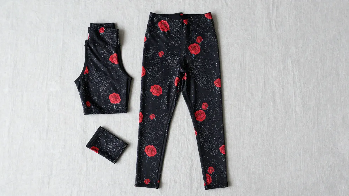 Mono B floral leggings with bold colorful flower print displayed on a light wooden bench